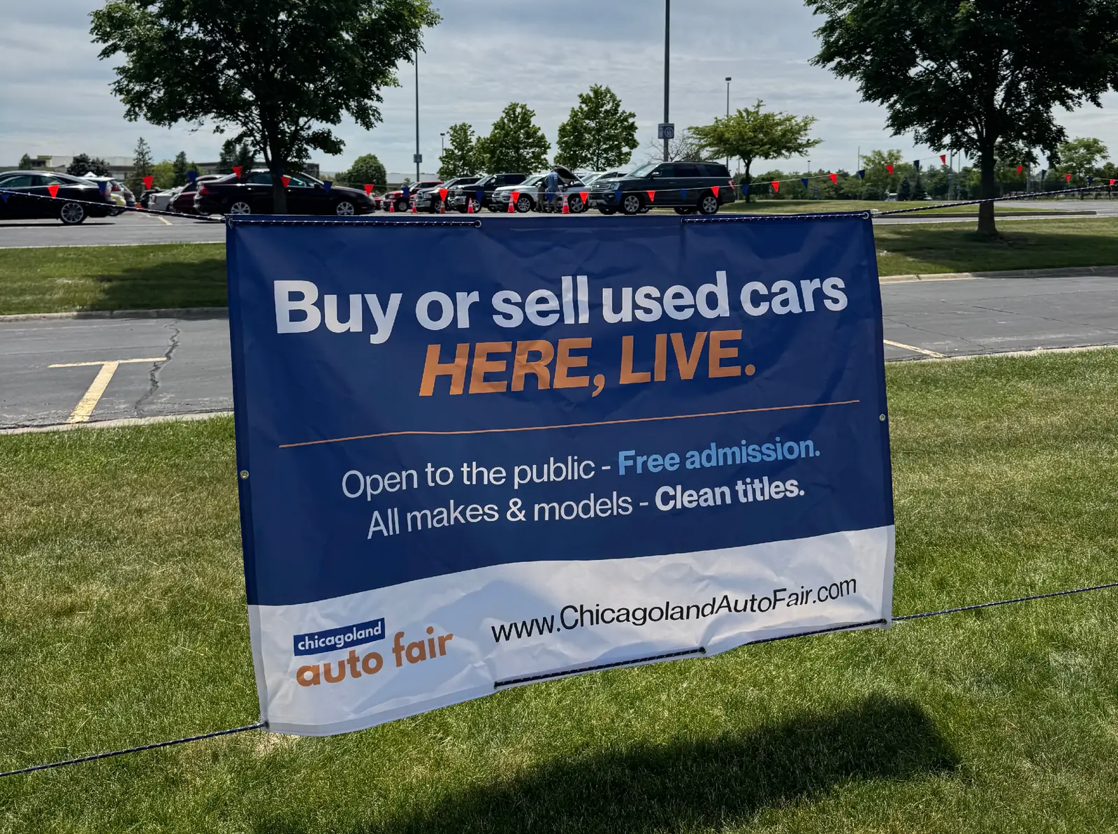 Chicagoland Auto Fair banner at the venue reading: Buy or sell used cars here, live. Open to the public, free admission, all makes and models, clean titles.