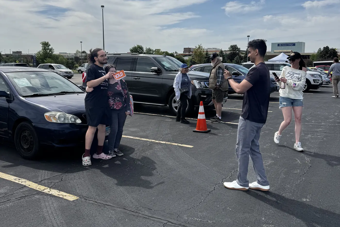 A buyer and seller with a sold sign on the lot at Event #1